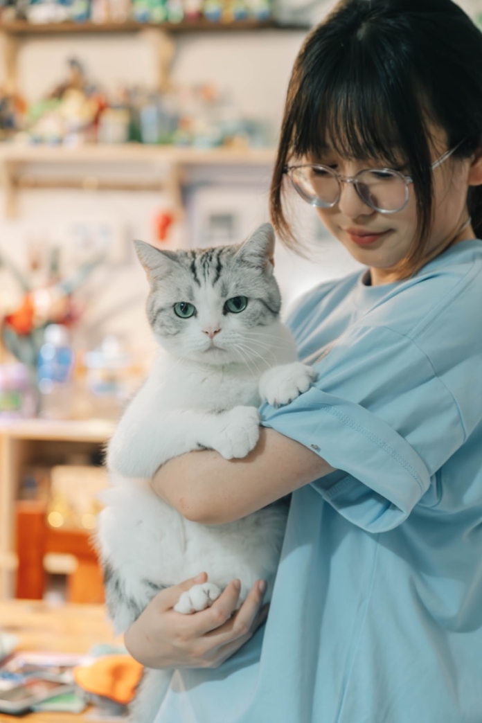 A woman holding a cat in her arms